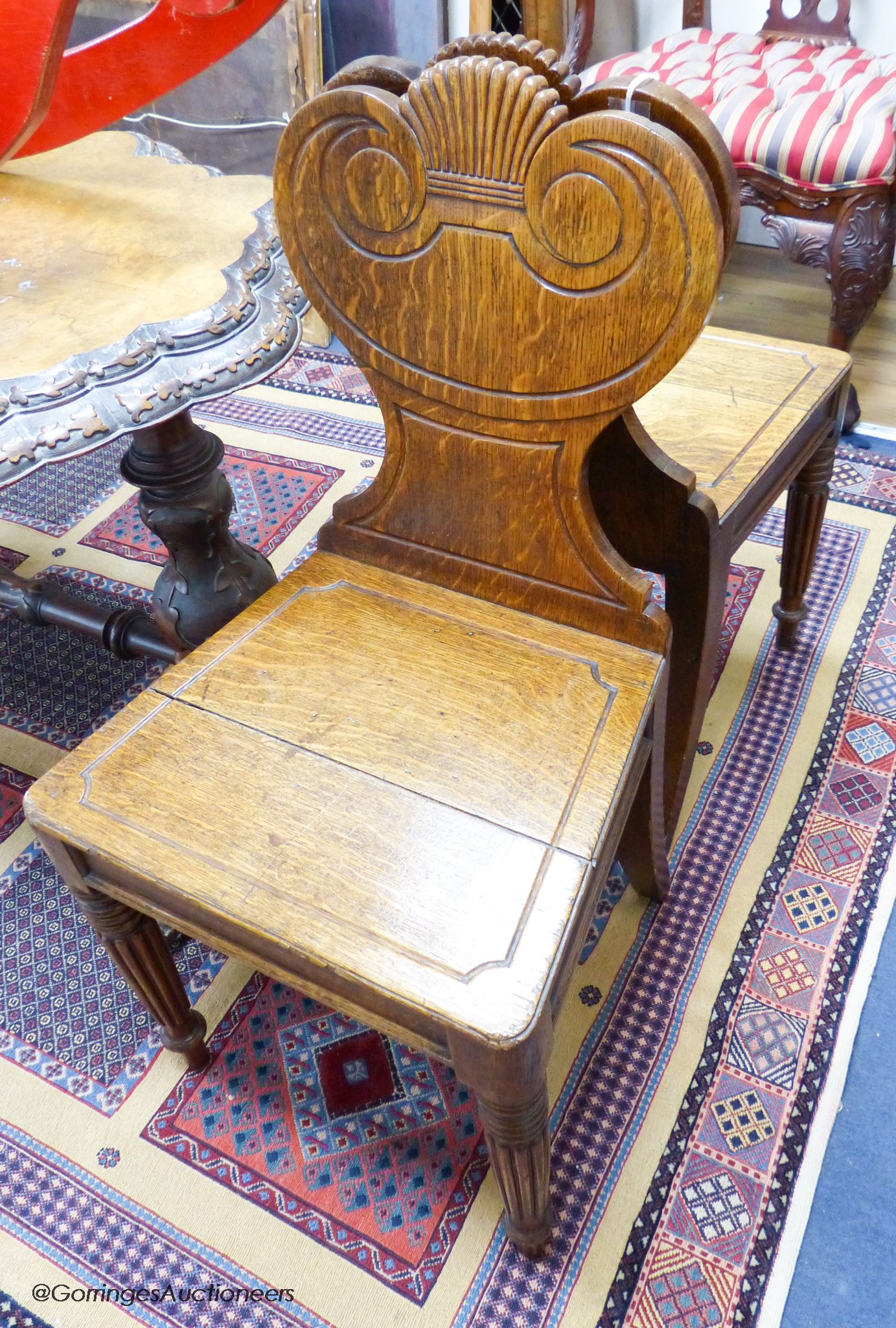 A pair of William IV oak hall chairs, stamped Gillows, Lancaster